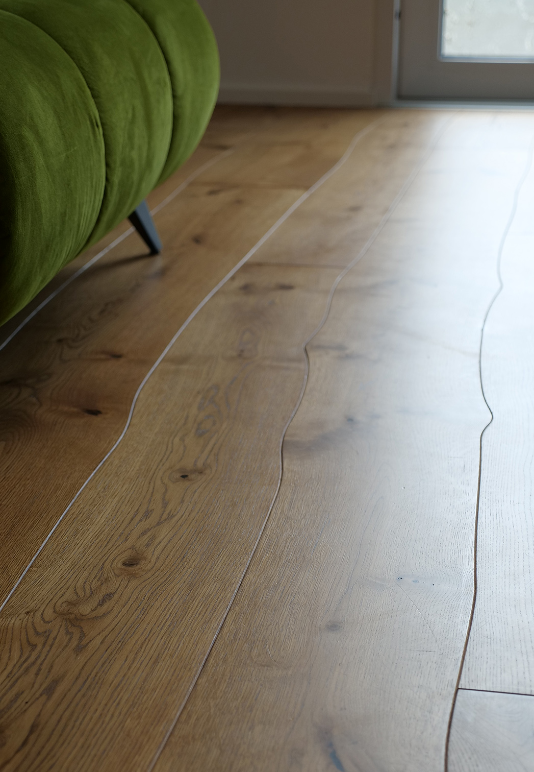 Curved Bolefloor in a living room with green sofa